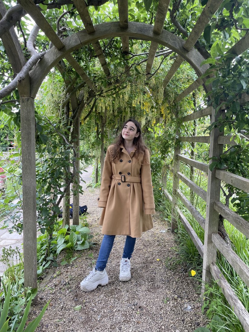 Under a garden arch hung with green.